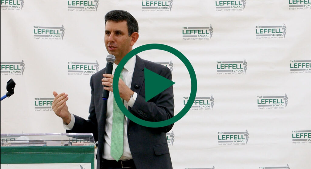 Dr. Michael Kay speaks with a microphone in front of a background with the logos of The Leffell School. A large green circular play button is overlaid. 